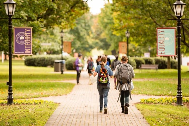 Two students walking in a campus